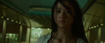 Movie still from “Blackhat” (2015), directed by Michael Mann – A woman with long black hair is looking at the camera; Close Up shot, Low angle