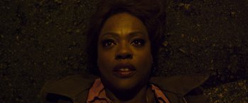 Movie still from “Blackhat” (2015), directed by Michael Mann – A woman's face with a dark background; Close Up shot, Overhead angle