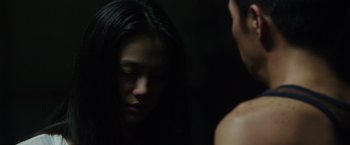 Movie still from “Blackhat” (2015), directed by Michael Mann – A woman looking at a man in the mirror; Close Up shot, Over the shoulder angle