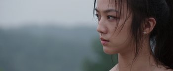 Movie still from “Blackhat” (2015), directed by Michael Mann – A person with long black hair; Close Up shot, Over the shoulder angle