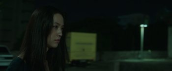 Movie still from “Blackhat” (2015), directed by Michael Mann – A young woman is standing in the dark; Close Up shot, Over the shoulder angle