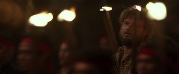 Movie still from “Blackhat” (2015), directed by Michael Mann – A man with a long beard is looking at the camera; Close Up shot, Over the shoulder angle