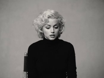 Movie still from “Blonde” (2022), directed by Andrew Dominik – A black and white photo of a woman with blonde hair; Medium shot, Low angle