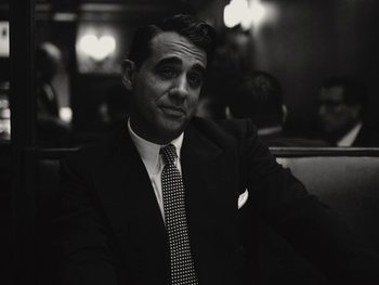 Movie still from “Blonde” (2022), directed by Andrew Dominik – Black and white photograph of a man in a suit and tie; Close Up shot, High angle