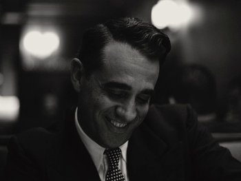 Movie still from “Blonde” (2022), directed by Andrew Dominik – Black and white photograph of a man in a suit and tie; Close Up shot, Low angle