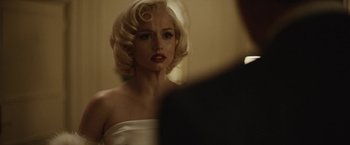 Movie still from “Blonde” (2022), directed by Andrew Dominik – A woman in a white dress looking into a mirror; Close Up shot, Over the shoulder angle