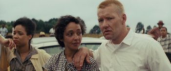 Movie still from “Loving” (2016), directed by Jeff Nichols – A man and a woman standing next to each other near a car; Close Up shot, Over the shoulder angle