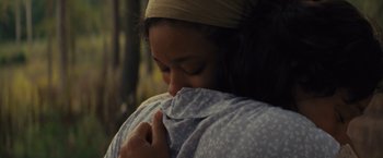 Movie still from “Loving” (2016), directed by Jeff Nichols – A woman is holding her head down while hugging a blanket; Close Up shot, Over the shoulder angle