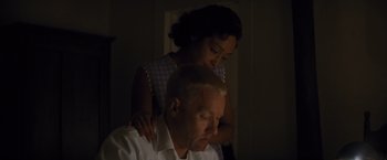 Movie still from “Loving” (2016), directed by Jeff Nichols – A woman standing next to an older man in a room; Close Up shot, High angle