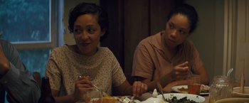 Movie still from “Loving” (2016), directed by Jeff Nichols – Two people sitting at a dinner table eating food; Medium shot, Over the shoulder angle