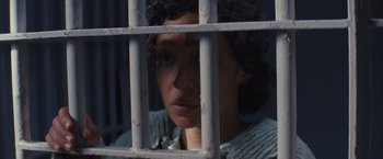 Movie still from “Loving” (2016), directed by Jeff Nichols – A woman looking through the bars of a jail cell; Close Up shot, High angle