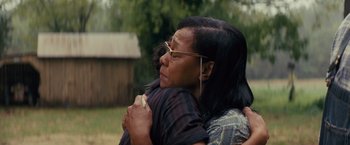 Movie still from “Loving” (2016), directed by Jeff Nichols – A woman hugging another woman outside in a yard; Close Up shot, Over the shoulder angle