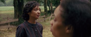 Movie still from “Loving” (2016), directed by Jeff Nichols – A woman standing next to another woman in a field; Close Up shot, Over the shoulder angle