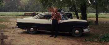 Movie still from “Loving” (2016), directed by Jeff Nichols – A man standing in front of an old car; Wide shot, Over the shoulder angle