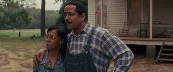 Movie still from “Loving” (2016), directed by Jeff Nichols – A man and a woman standing next to each other; Medium shot, Low angle