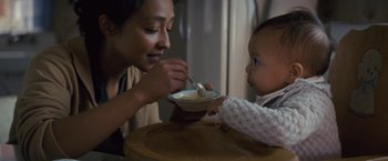 Movie still from “Loving” (2016), directed by Jeff Nichols – A woman feeding a baby from a bowl with a spoon; Close Up shot, High angle