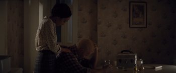 Movie still from “Loving” (2016), directed by Jeff Nichols – A man and a woman sitting at a kitchen table; Medium shot, High angle