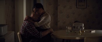 Movie still from “Loving” (2016), directed by Jeff Nichols – A woman and a man hugging in a room; Medium shot, High angle