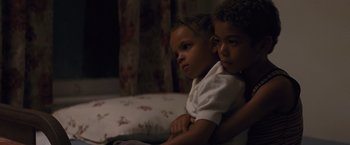 Movie still from “Loving” (2016), directed by Jeff Nichols – Two young children sitting next to each other on a bed; Close Up shot, High angle