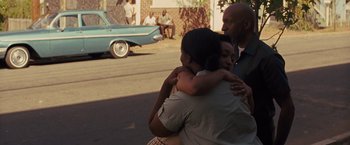 Movie still from “Loving” (2016), directed by Jeff Nichols – A group of people hugging on the side of the road; Medium shot, Over the shoulder angle