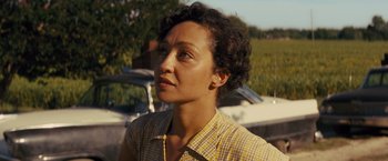 Movie still from “Loving” (2016), directed by Jeff Nichols – A woman in a yellow plaid shirt looking to her left; Close Up shot, Over the shoulder angle