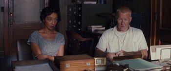 Movie still from “Loving” (2016), directed by Jeff Nichols – A man and a woman sitting at a table; Medium shot, High angle