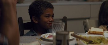 Movie still from “Loving” (2016), directed by Jeff Nichols – A boy sitting at a table with a plate of food in front of him; Close Up shot, Over the shoulder angle