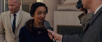 Movie still from “Loving” (2016), directed by Jeff Nichols – A woman is being interviewed by a man holding a microphone in her hand; Close Up shot, Over the shoulder angle