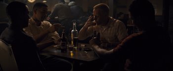 Movie still from “Loving” (2016), directed by Jeff Nichols – A group of people sitting at a table with drinks; Medium shot, Over the shoulder angle
