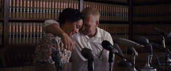 Movie still from “Loving” (2016), directed by Jeff Nichols – A man and a woman sitting in front of microphones; Medium shot, High angle
