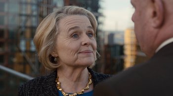 Movie still from “Marcella” (2016), created by Hans Rosenfeldt – An older woman wearing a gold necklace looking at the camera; Close Up shot, Over the shoulder angle