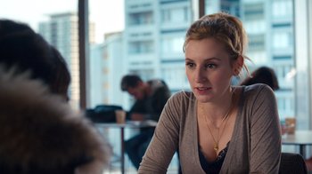 Movie still from “Marcella” (2016), created by Hans Rosenfeldt – A woman sitting at a table in front of a window; Close Up shot, Over the shoulder angle