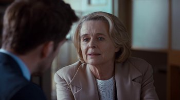 Movie still from “Marcella” (2016), created by Hans Rosenfeldt – An older woman sitting in front of a younger man; Close Up shot, Over the shoulder angle