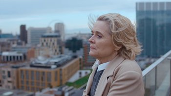 Movie still from “Marcella” (2016), created by Hans Rosenfeldt – An older woman looking out over a city; Close Up shot, Over the shoulder angle