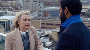 Movie still from “Marcella” (2016), created by Hans Rosenfeldt – Two people are talking on a balcony overlooking a city; Close Up shot, Over the shoulder angle