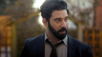Movie still from “Marcella” (2016), created by Hans Rosenfeldt – A man with a beard wearing a suit and tie; Close Up shot, Over the shoulder angle