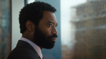 Movie still from “Marcella” (2016), created by Hans Rosenfeldt – A person wearing a suit and tie; Close Up shot, Low angle