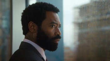 Movie still from “Marcella” (2016), created by Hans Rosenfeldt – A person wearing a suit and tie; Close Up shot, Low angle