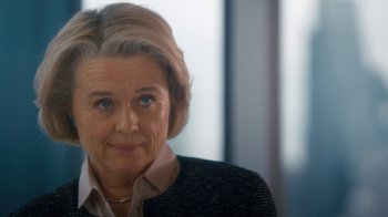 Movie still from “Marcella” (2016), created by Hans Rosenfeldt – An older woman is smiling for the camera; Close Up shot, Over the shoulder angle
