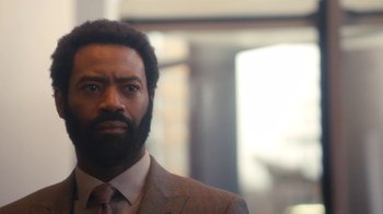 Movie still from “Marcella” (2016), created by Hans Rosenfeldt – A person wearing a suit and tie; Close Up shot, Low angle