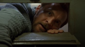 Movie still from “Marcella” (2016), created by Hans Rosenfeldt – A person leaning on a wall; Close Up shot, Overhead angle