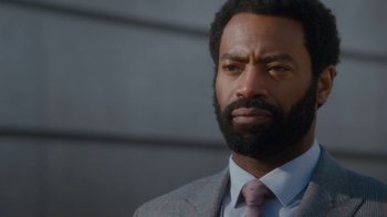 Movie still from “Marcella” (2016), created by Hans Rosenfeldt – A person wearing a suit and tie; Close Up shot, Over the shoulder angle