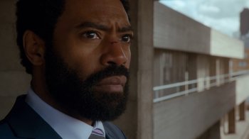 Movie still from “Marcella” (2016), created by Hans Rosenfeldt – A person wearing a suit and tie; Close Up shot, Low angle