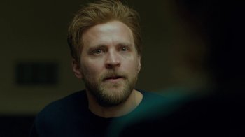 Movie still from “Marcella” (2016), created by Hans Rosenfeldt – A person with a beard; Close Up shot, Over the shoulder angle