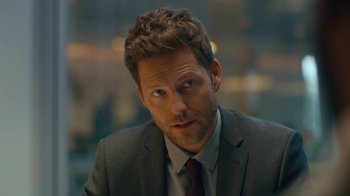 Movie still from “Marcella” (2016), created by Hans Rosenfeldt – A person wearing a suit and tie; Close Up shot, Over the shoulder angle