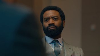 Movie still from “Marcella” (2016), created by Hans Rosenfeldt – A man in a suit and tie looking into a mirror; Close Up shot, Over the shoulder angle