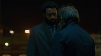 Movie still from “Marcella” (2016), created by Hans Rosenfeldt – A man in a suit and tie talking to another man in a suit and tie; Medium shot, Over the shoulder angle