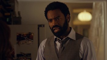 Movie still from “Marcella” (2016), created by Hans Rosenfeldt – A man in a vest and a tie looking at the camera; Close Up shot, Over the shoulder angle