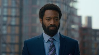 Movie still from “Marcella” (2016), created by Hans Rosenfeldt – A person wearing a suit and tie; Close Up shot, Over the shoulder angle