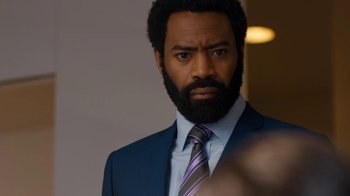 Movie still from “Marcella” (2016), created by Hans Rosenfeldt – A man in a blue suit and a purple striped tie; Close Up shot, Over the shoulder angle